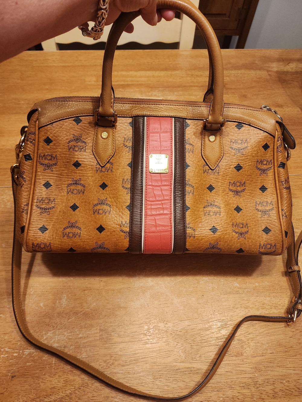MCM Visetos monogram satchel featuring a distinctive red and brown embossed